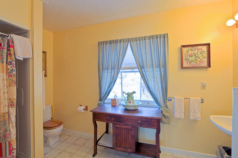 71 Deadwood Road Lewiston, CA 96052 - Photo 17 of 39 a view of a bath room with a window and wooden floor