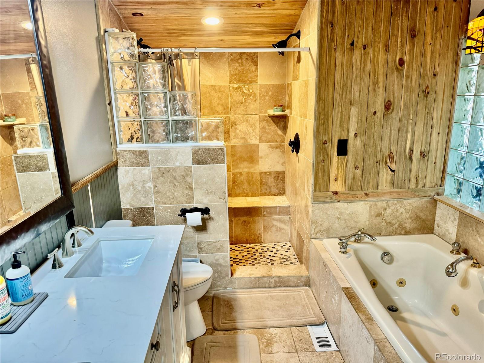 1254 South Reed Street, Unit 1 Lakewood, CO 80232 - Photo 13 of 19 a bathroom with a tub sink and mirror