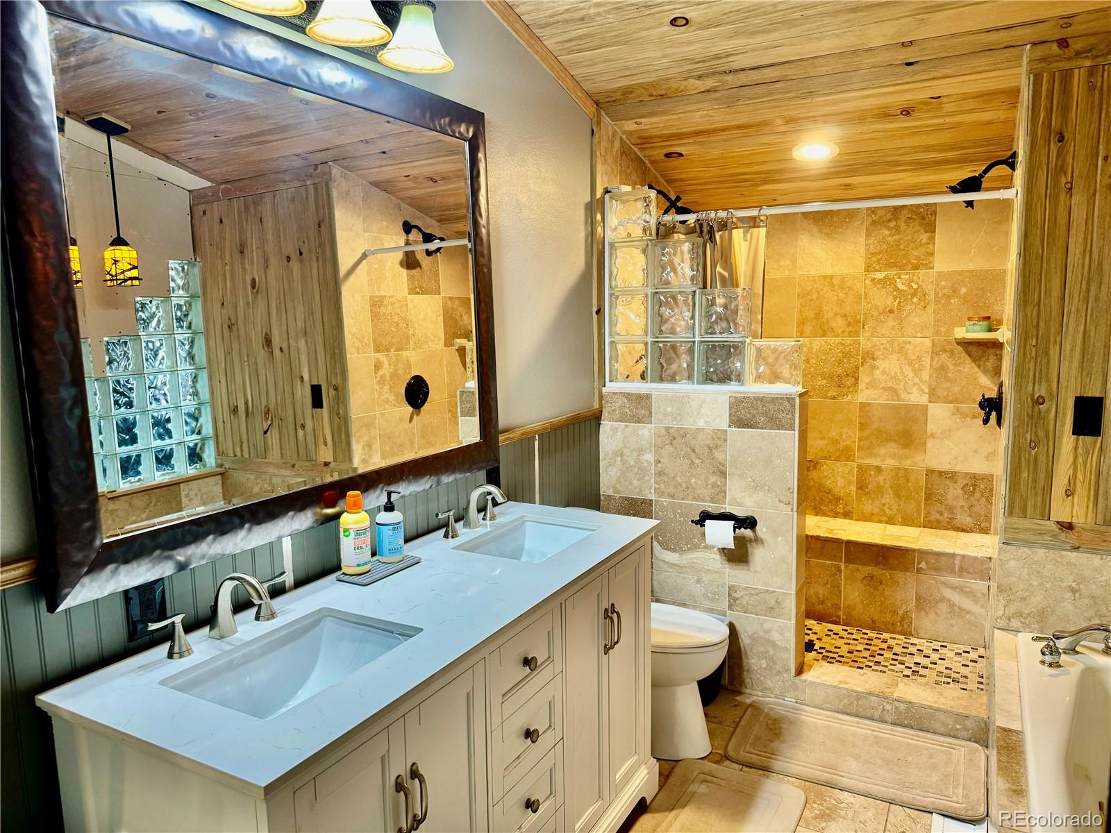 1254 South Reed Street, Unit 1 Lakewood, CO 80232 - Photo 14 of 19 a bathroom with a granite countertop sink toilet and shower