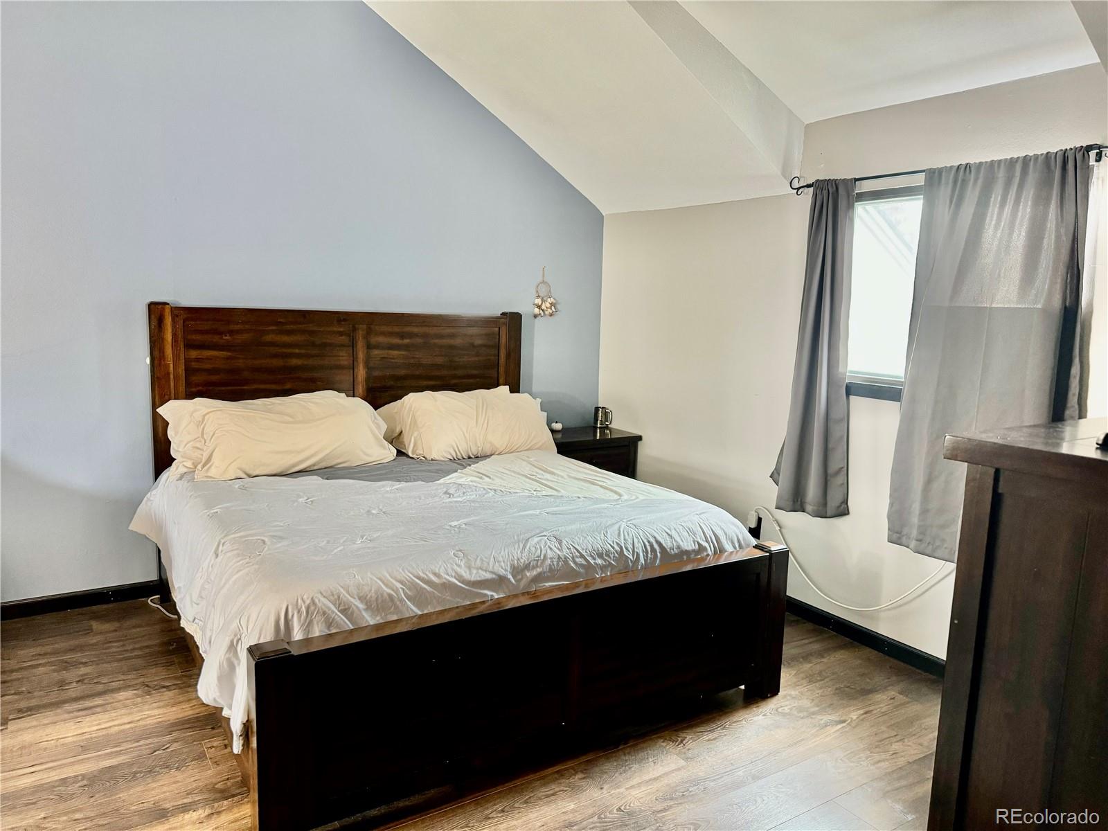 1254 South Reed Street, Unit 1 Lakewood, CO 80232 - Photo 10 of 19 a bedroom with a bed and a mirror
