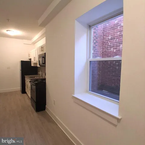 a kitchen with a refrigerator and a stove