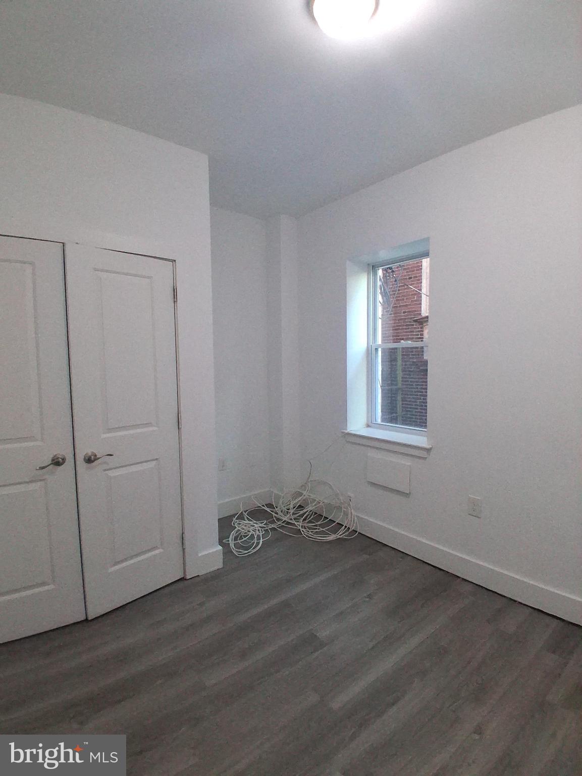 6104 Market Street, Unit 2 Philadelphia, PA 19139 - Photo 5 of 11 a view of an empty room with closet and a window