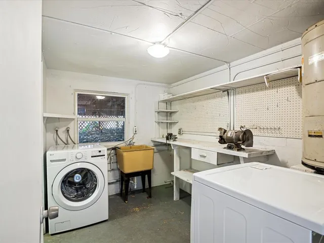 a view of empty room with refrigerator and cabinet