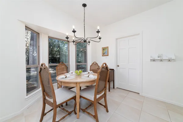 a view of a dining room with furniture and chandelier