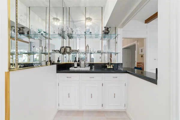 a bathroom with double vanity and a bathtub
