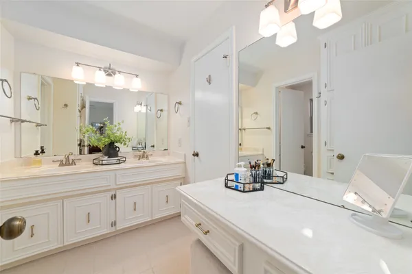 a bathroom with a double vanity sink mirror and