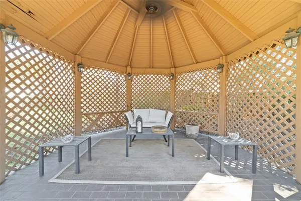 a white bench sitting in front of a bathroom
