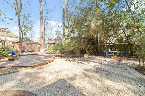 a view of a backyard with large trees