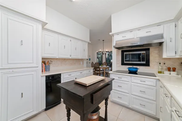 a kitchen with a sink cabinets and wooden floor