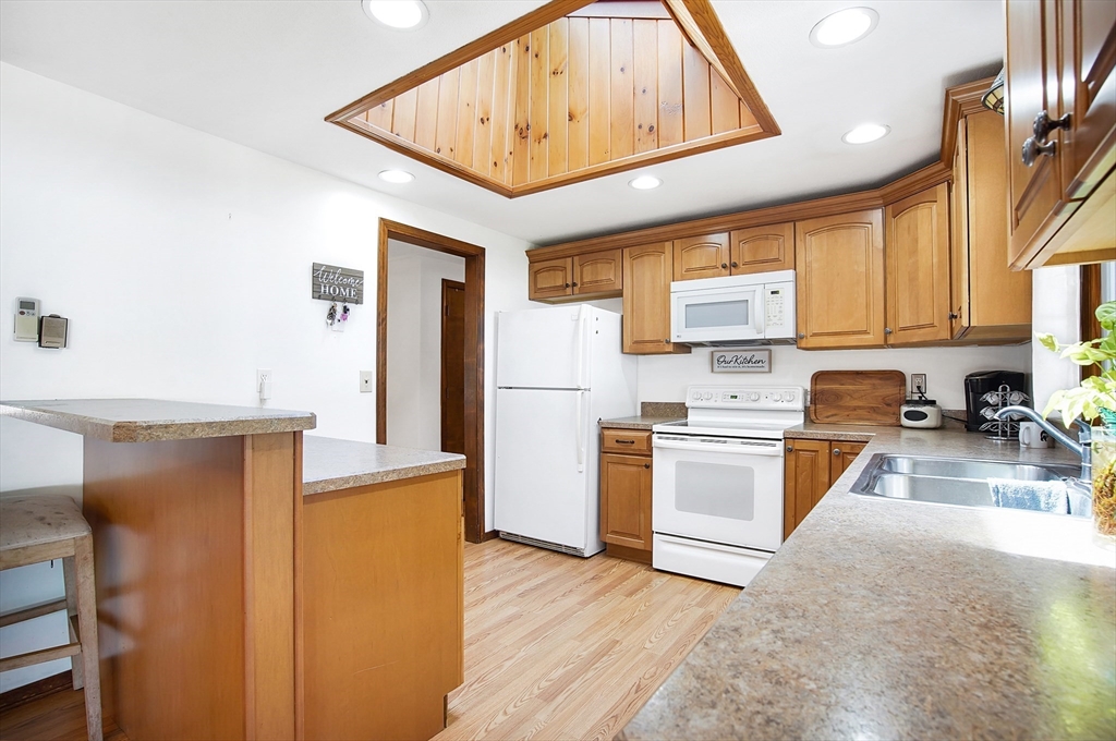 17 Beach Road Ware, MA 01082 - Photo 7 of 41 a kitchen with a refrigerator a stove top oven a sink and dishwasher