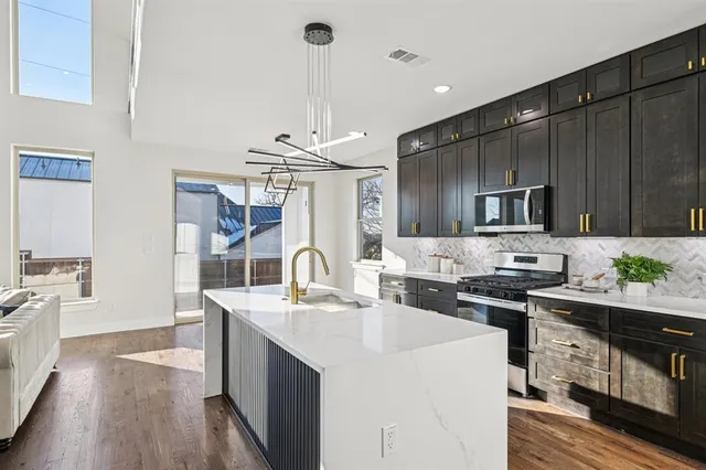 a kitchen with a sink stove and refrigerator