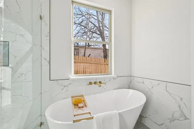a white bath tub sitting next to a white sink