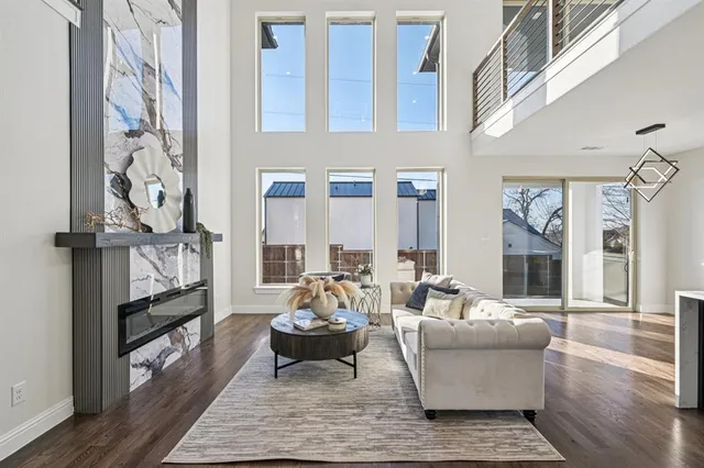 a living room with fireplace furniture and a wooden floor