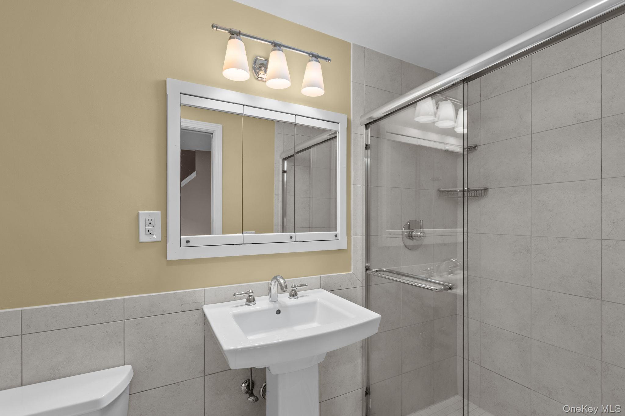 2211 Crompond Road Yorktown Heights, NY 10598 - Photo 29 of 38 a bathroom with a sink a toilet and shower