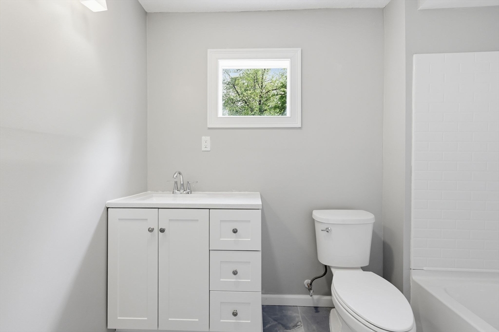 62 Kenyon Street Springfield, MA 01109 - Photo 19 of 26 a bathroom with a toilet a sink and mirror