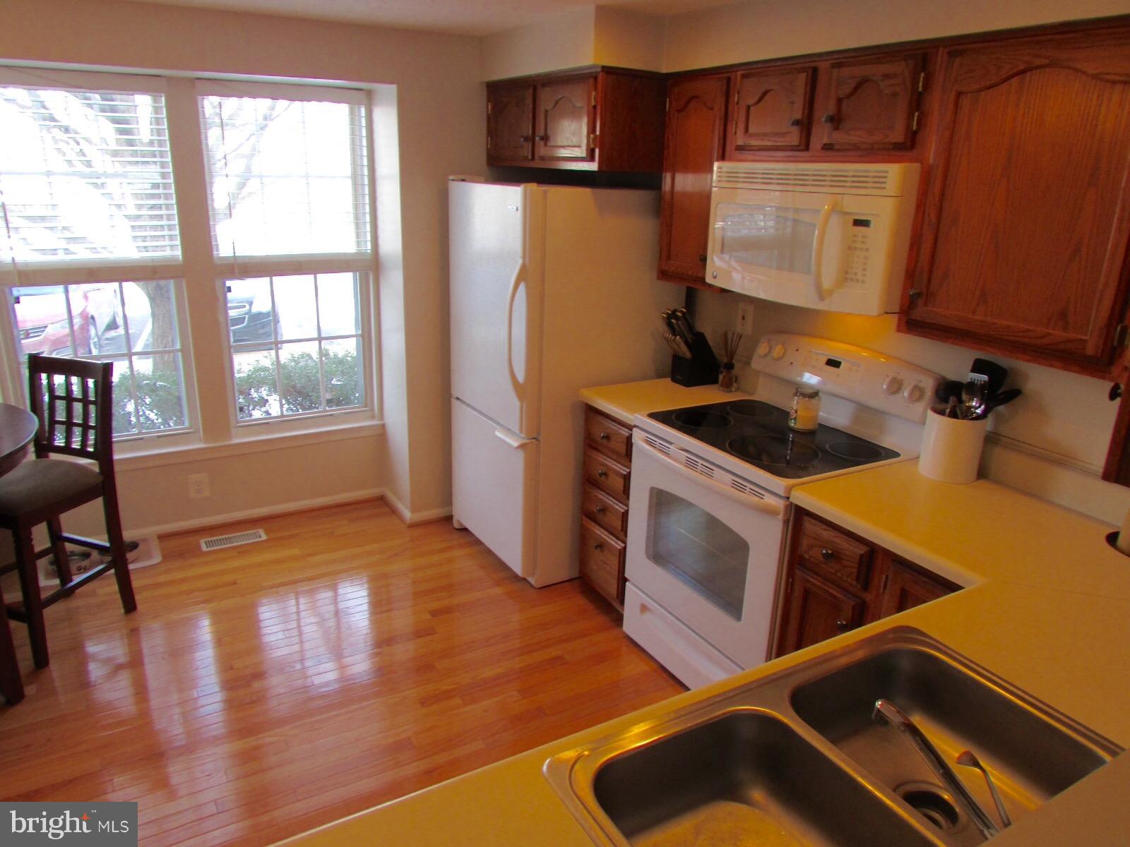 571 Quaker Ridge Court Arnold, MD 21012 - Photo 2 of 17 a kitchen with a refrigerator and a stove top oven