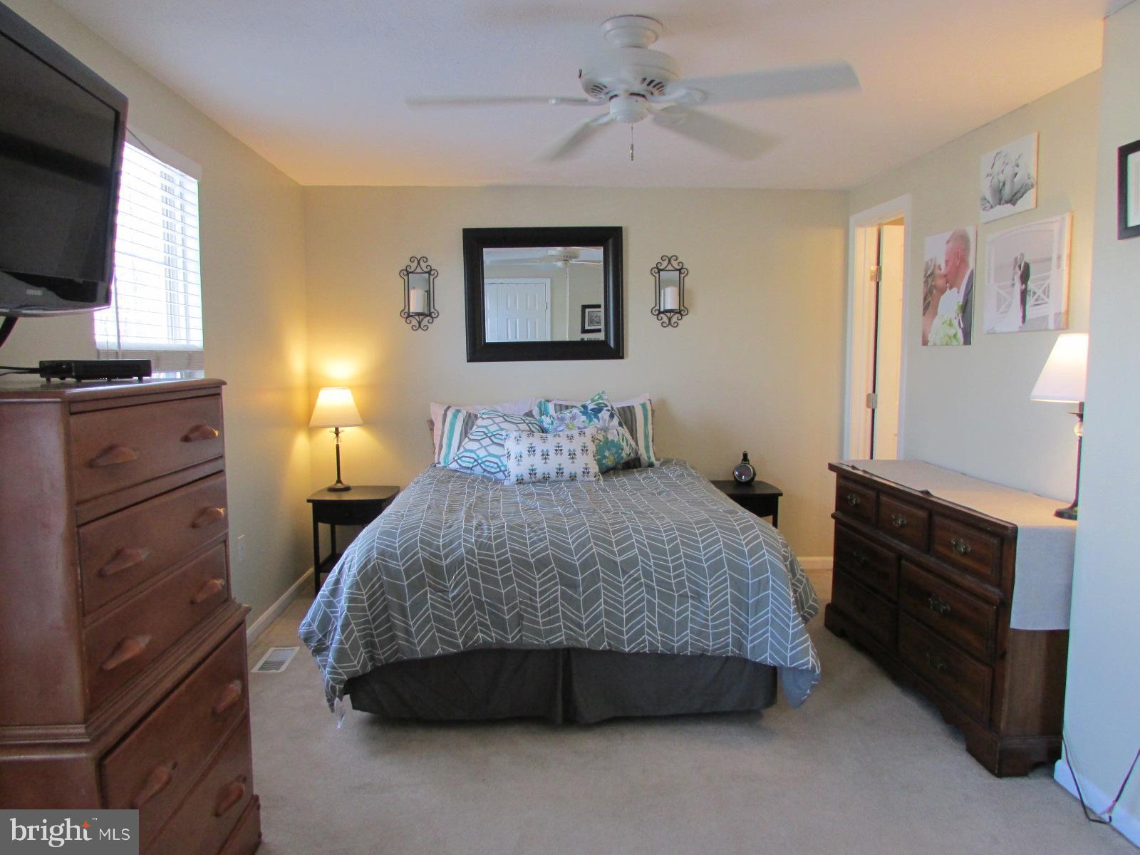 571 Quaker Ridge Court Arnold, MD 21012 - Photo 5 of 17 a spacious bedroom with a bed and a flat screen tv