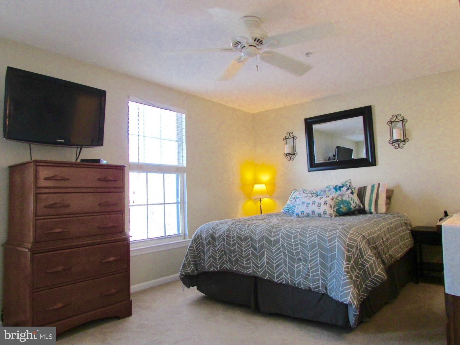 571 Quaker Ridge Court Arnold, MD 21012 - Photo 6 of 17 a bedroom with a bed and a flat screen tv