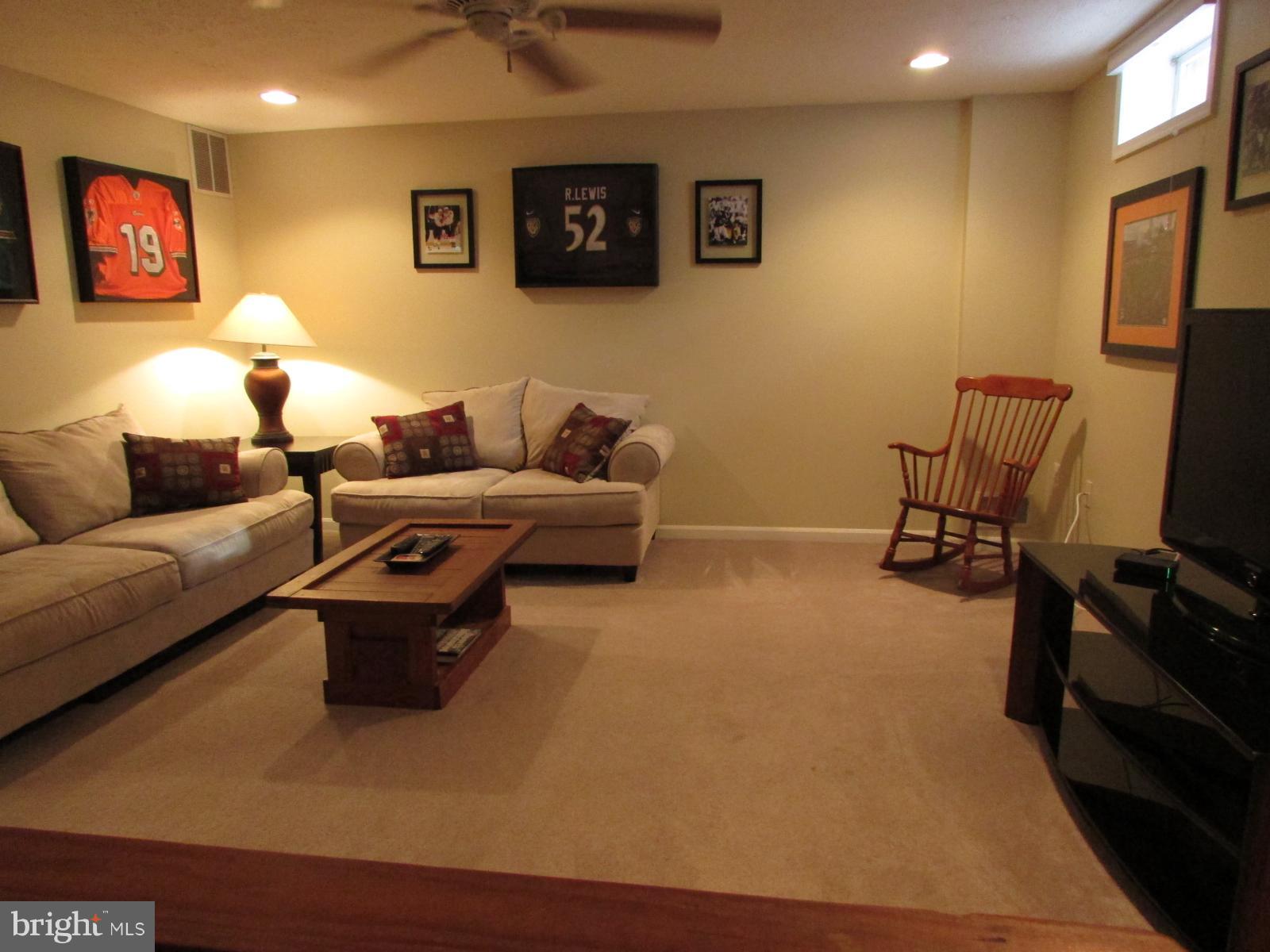 571 Quaker Ridge Court Arnold, MD 21012 - Photo 10 of 17 a living room with furniture and a flat screen tv