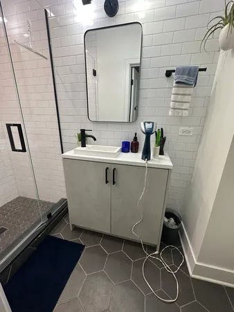 a room with a sink and a mirror