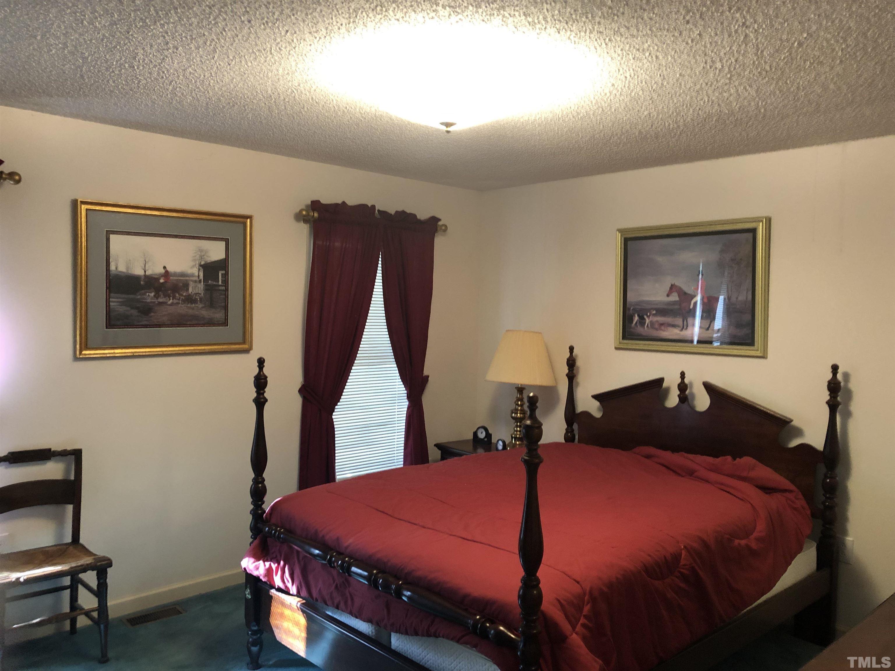 1885 Old Allensville Road Roxboro, NC 27574 - Photo 6 of 9 a bedroom with a bed and a dresser