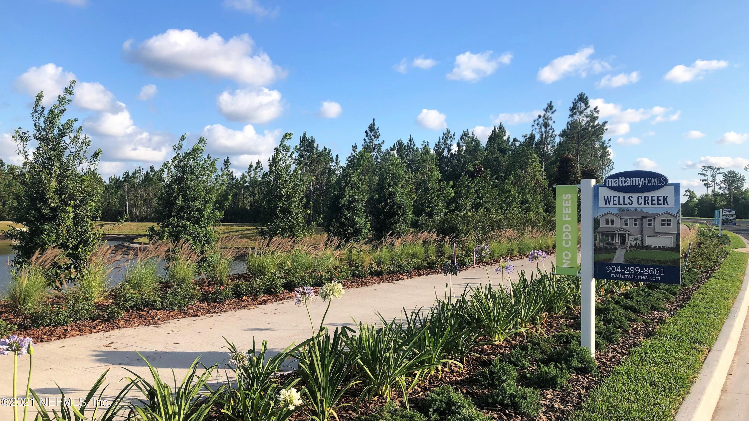 13116 Dunwick Road Jacksonville, FL 32256 - Photo 25 of 26 a view of a garden with a building in the background