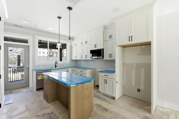 a kitchen with stainless steel appliances granite countertop a sink a stove and a refrigerator