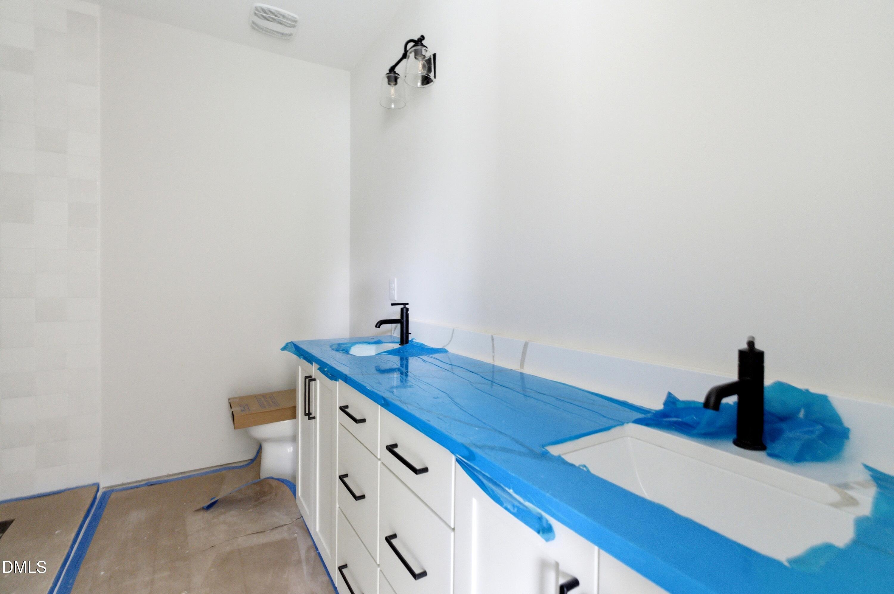 720 Noble Town Way, Unit 104 Raleigh, NC 27603 - Photo 12 of 21 a bathroom with a sink and mirror