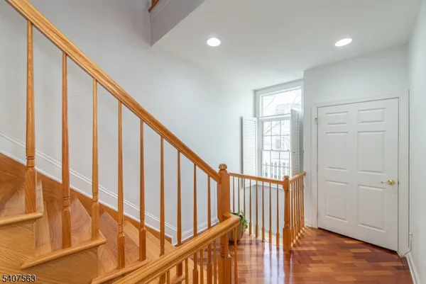 a view of entryway with wooden floor and stairs