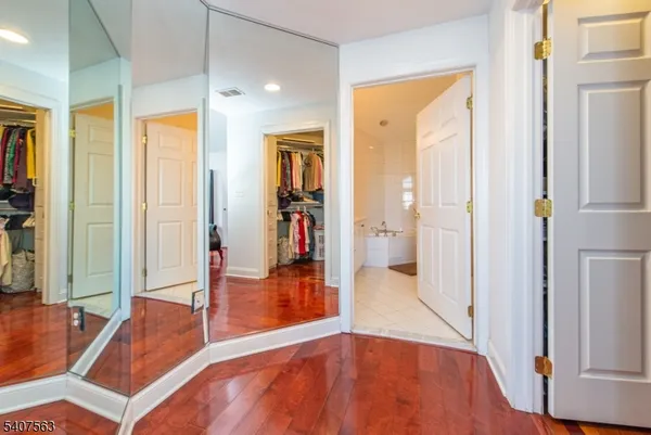 a bathroom with a double vanity sink mirror double shower and a toilet