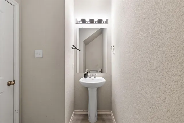 a view of a hallway with workspace and wooden floor
