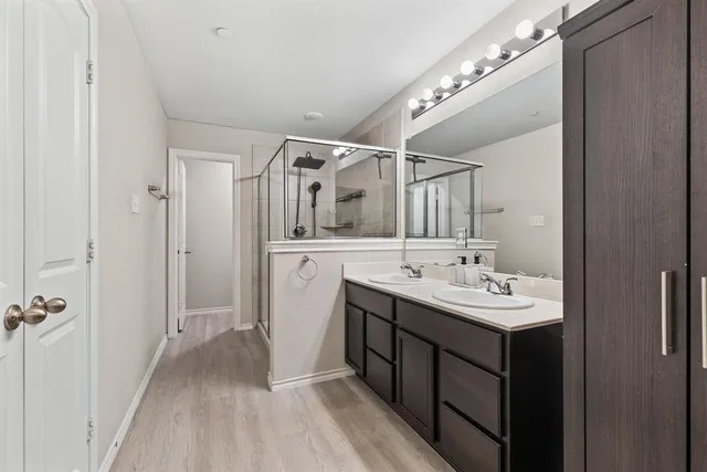 a bathroom with a double vanity sink and a mirror