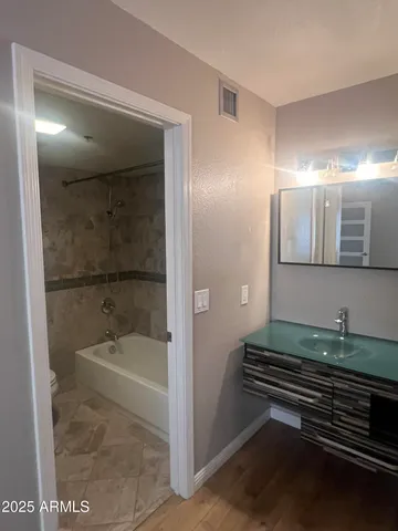 a bathroom with a tub and a mirror