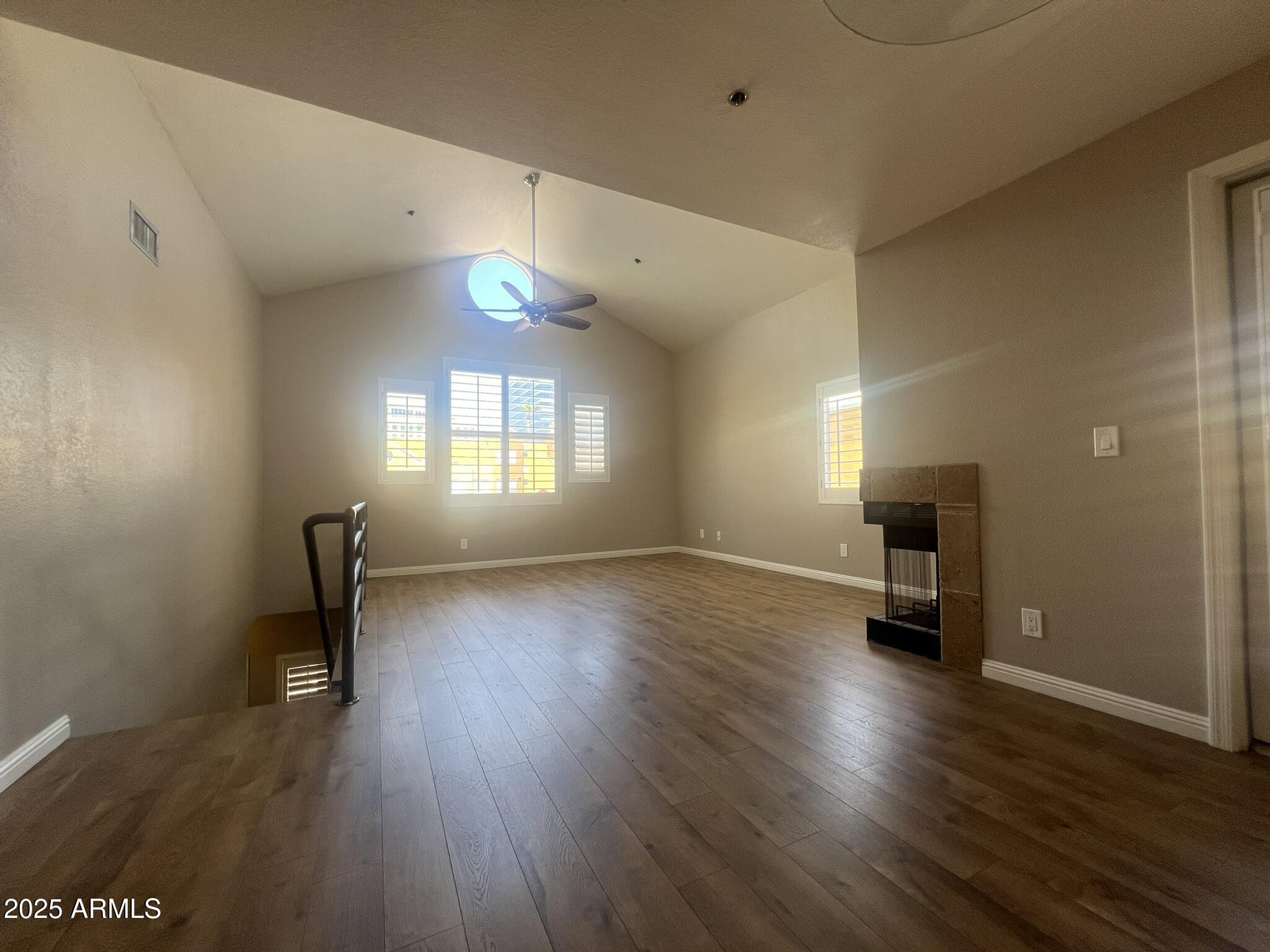 154 West 5th Street, Unit 248 Tempe, AZ 85281 - Photo 2 of 18 an empty room with wooden floor and windows