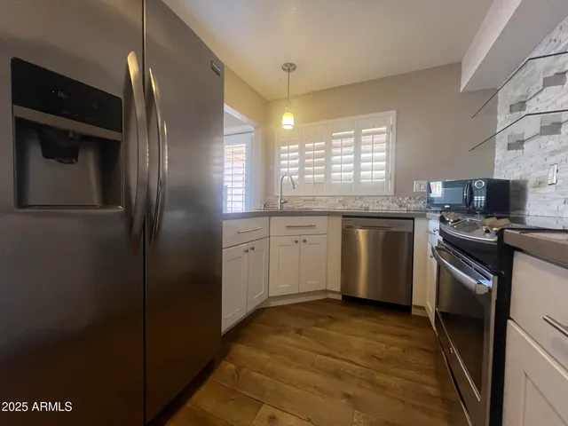 a kitchen with cabinets and stainless steel appliances