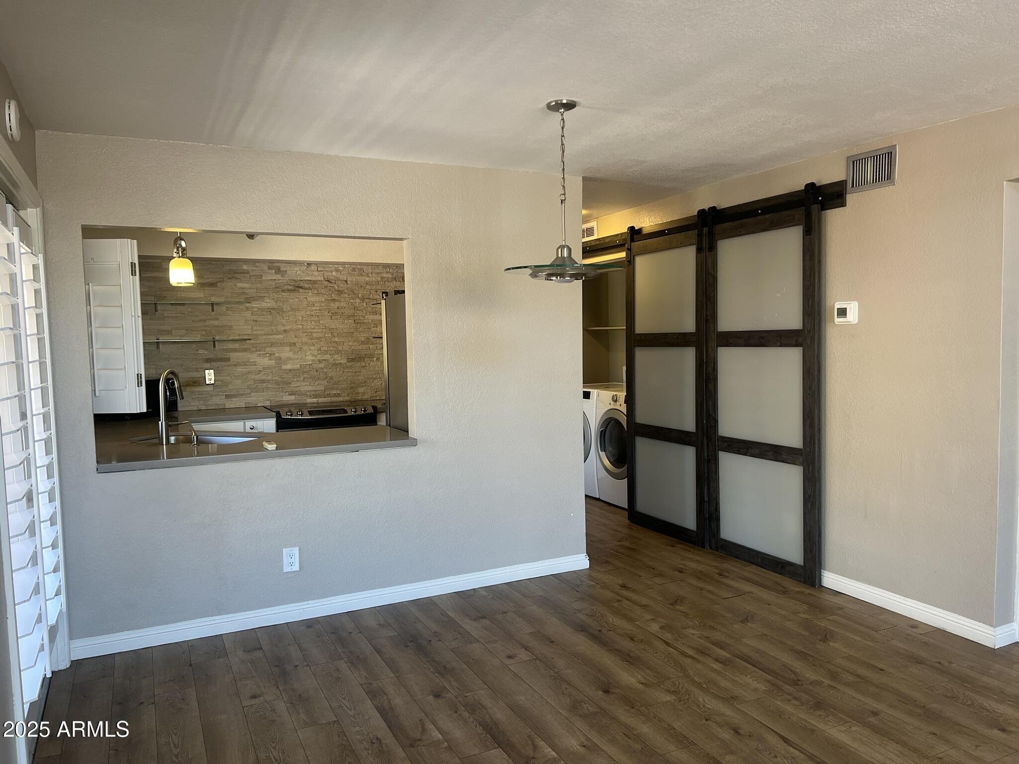 154 West 5th Street, Unit 248 Tempe, AZ 85281 - Photo 8 of 18 a view of empty room with wooden floor and fan