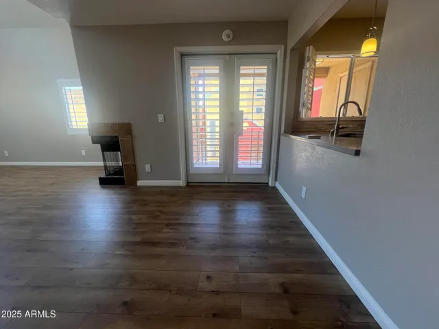 a view of a room with wooden floor and a window