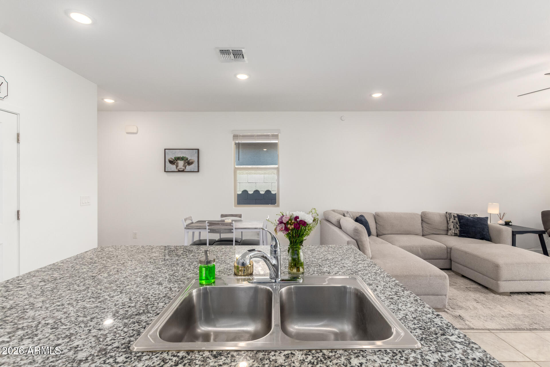 39985 West Rio Lobo Drive Maricopa, AZ 85138 - Photo 12 of 44 a kitchen with kitchen island a sink and a couch