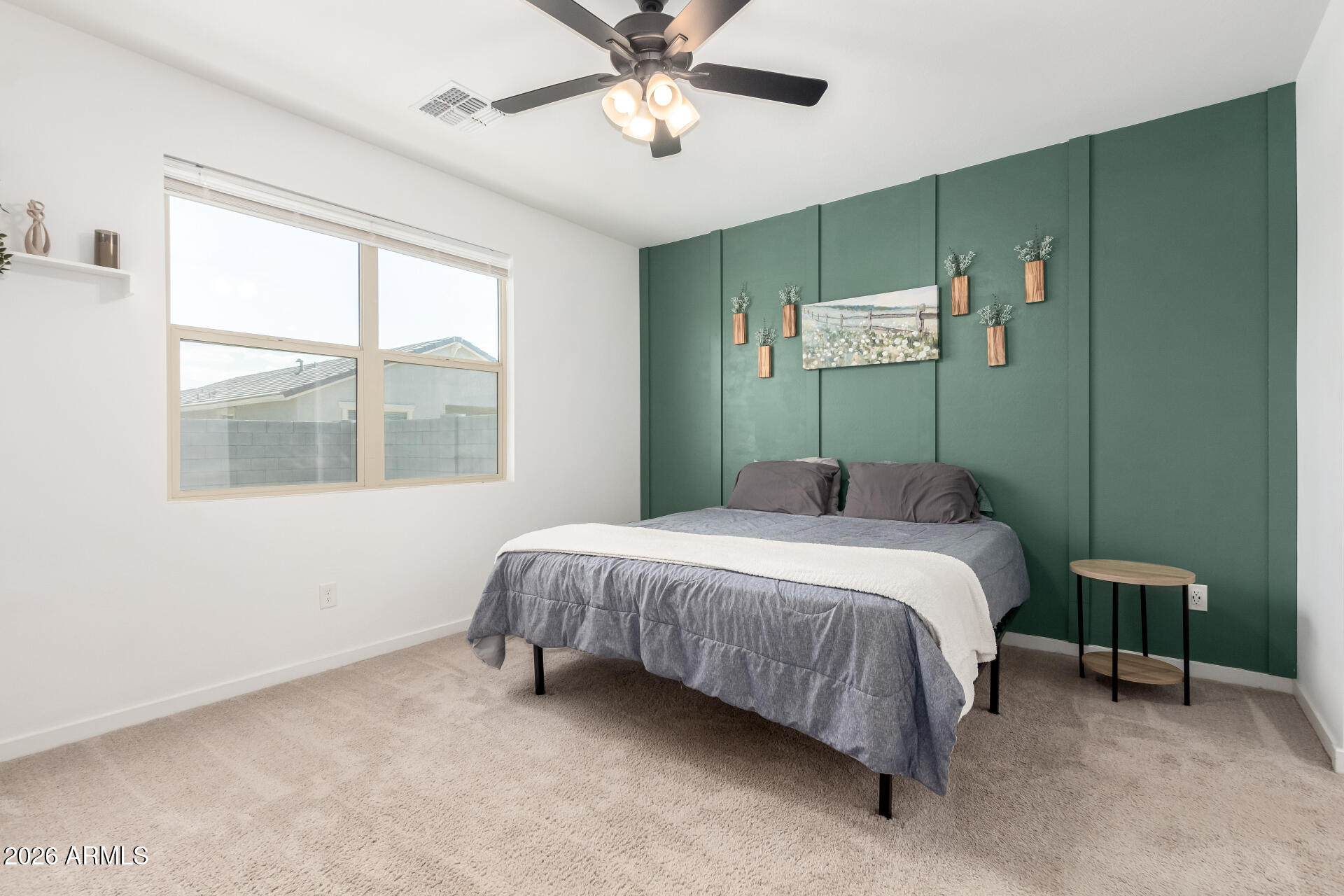 39985 West Rio Lobo Drive Maricopa, AZ 85138 - Photo 13 of 44 a bedroom with a bed mirror and a window
