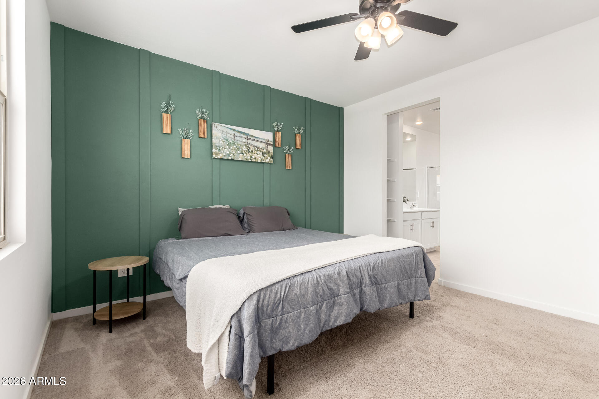 39985 West Rio Lobo Drive Maricopa, AZ 85138 - Photo 14 of 44 a bedroom with a bed and a chandelier