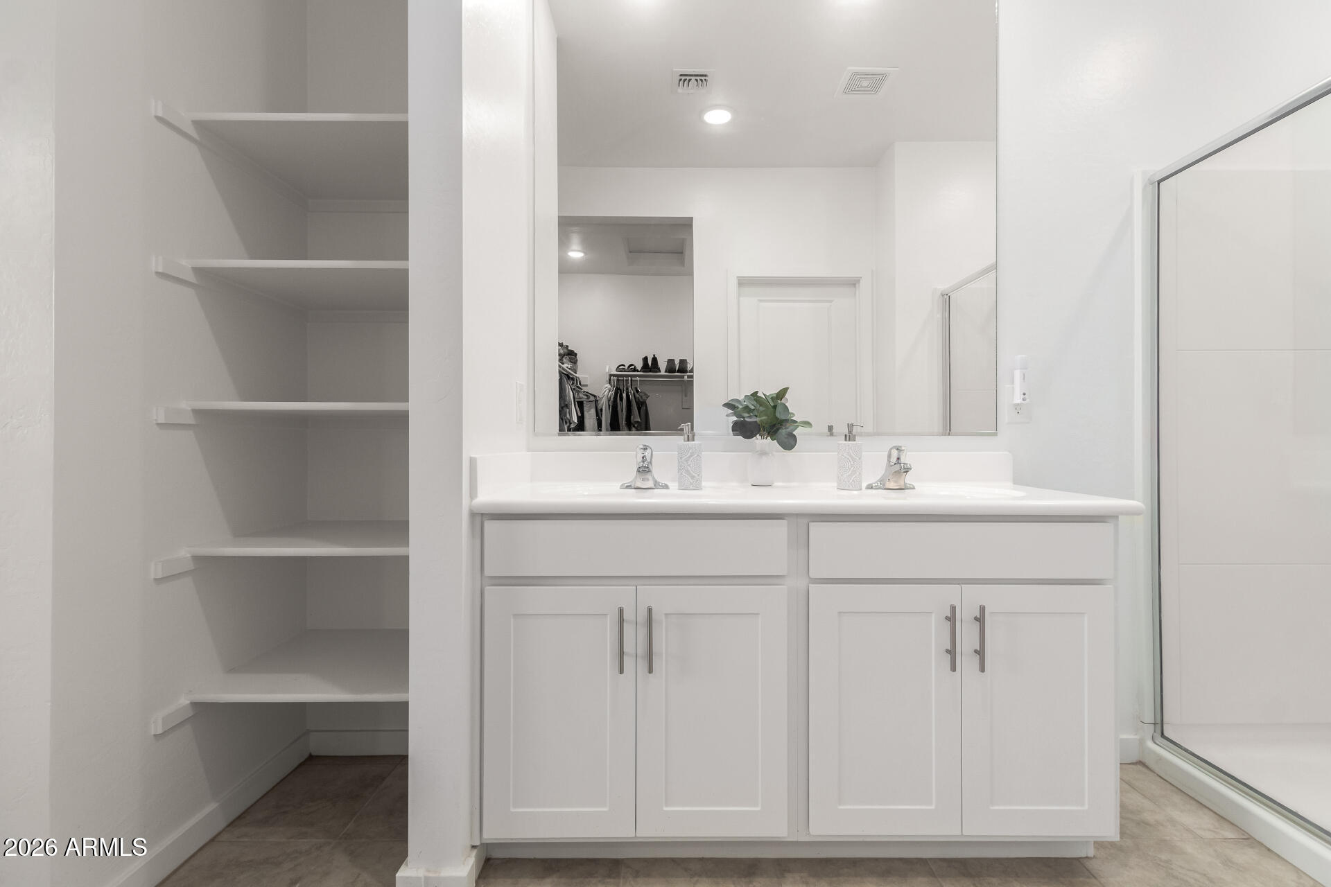 39985 West Rio Lobo Drive Maricopa, AZ 85138 - Photo 16 of 44 a bathroom with a sink vanity and a mirror