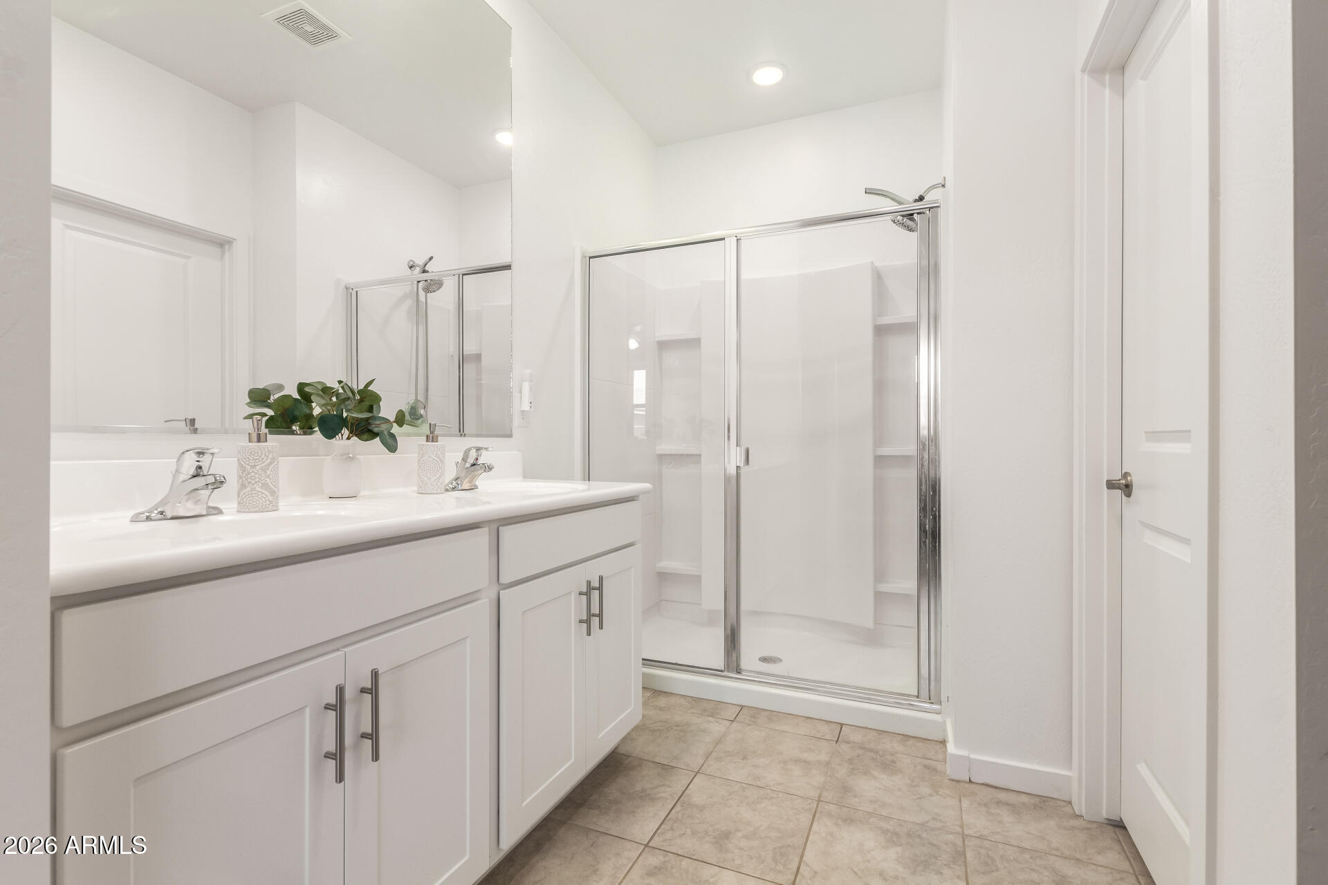 39985 West Rio Lobo Drive Maricopa, AZ 85138 - Photo 17 of 44 a spacious bathroom with a shower sink and mirror