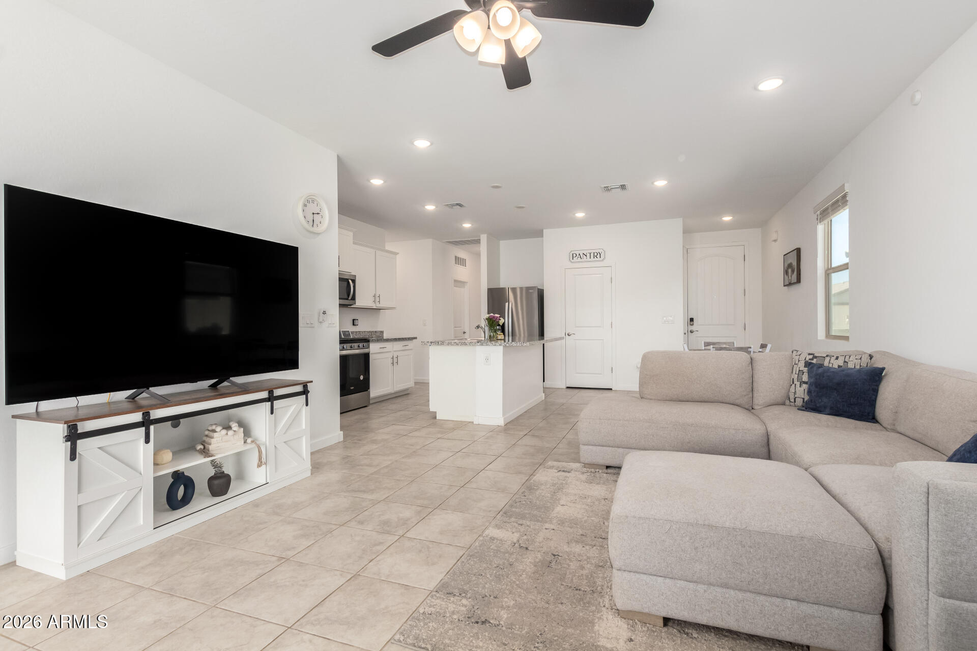 39985 West Rio Lobo Drive Maricopa, AZ 85138 - Photo 5 of 44 a living room with furniture and a flat screen tv