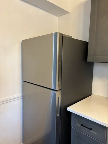 a white refrigerator freezer sitting in a kitchen
