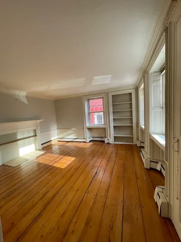 a view of a room with wooden floor and chair