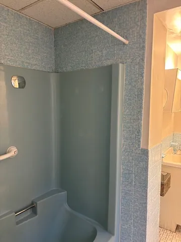 a bathroom with a sink a toilet and mirror
