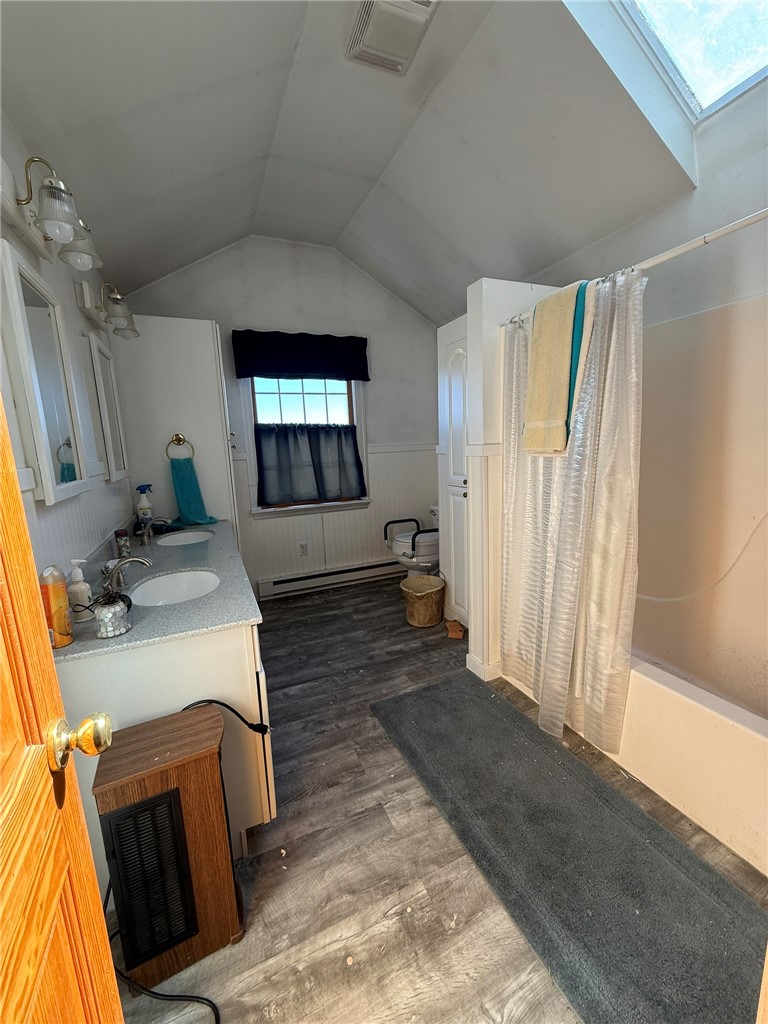 6617 Sweet Potato Ridge Road Englewood, OH 45322 - Photo 33 of 33 This bright bathroom features a vaulted ceiling, providing an open and airy feel.
