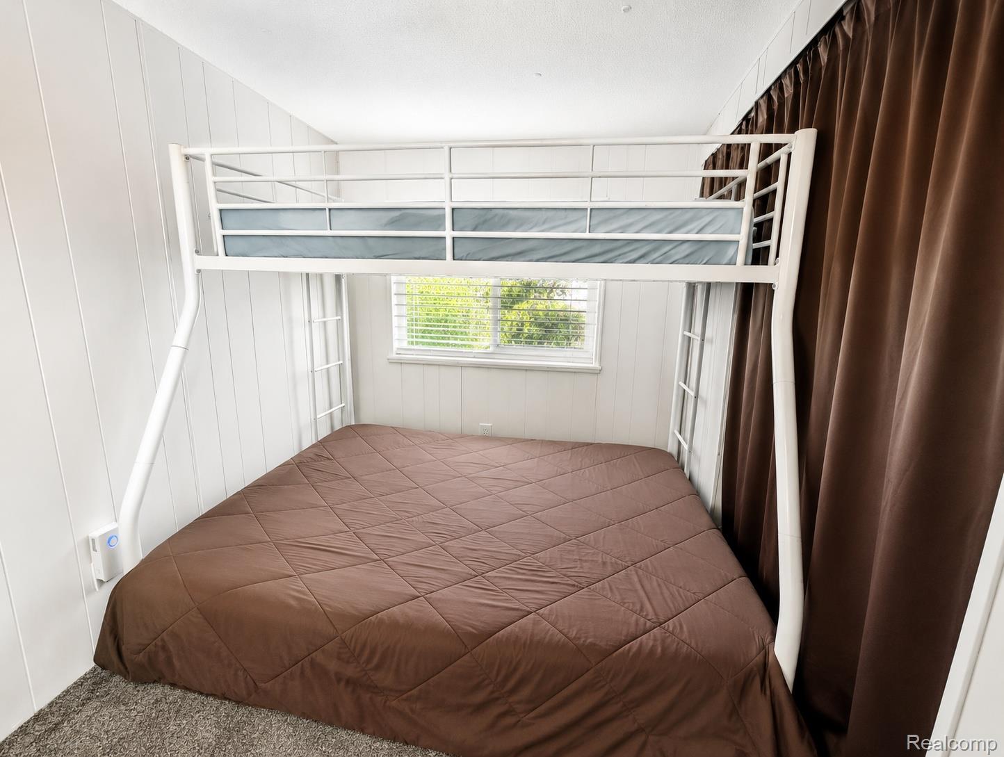 643 North Hockaday Road Gladwin, MI 48624 - Photo 9 of 24 Built-in bunk bed structure with a lower queen-size mattress and an upper twin mattress