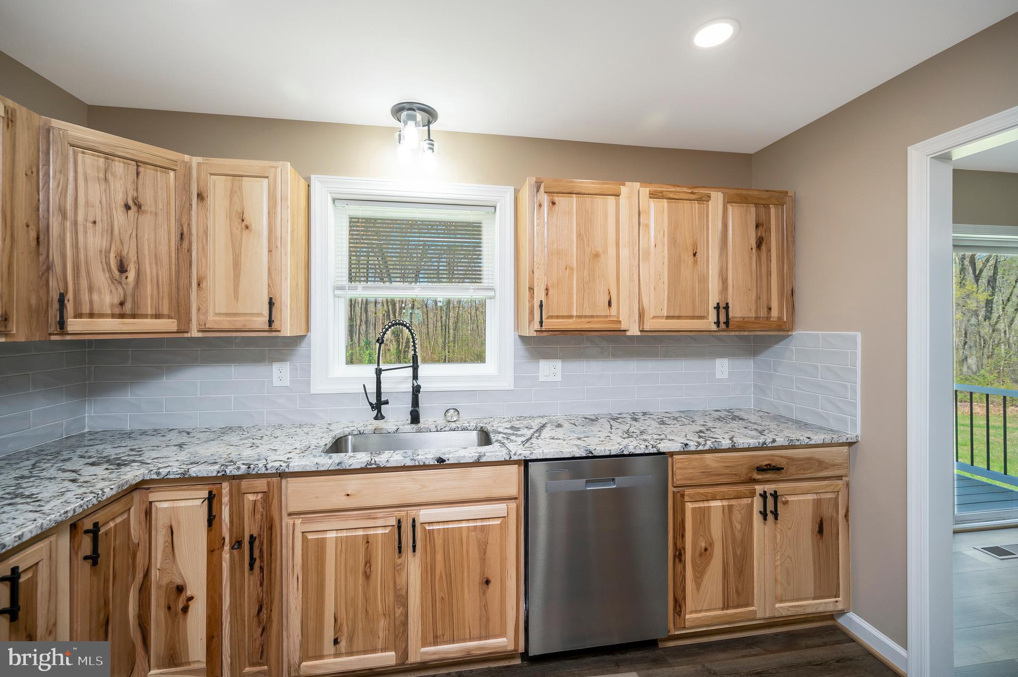 13452 Post Oak Road Spotsylvania, VA 22551 - Photo 26 of 56 a kitchen with granite countertop cabinets sink and window