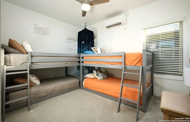 a bedroom with bunk bed and a desk